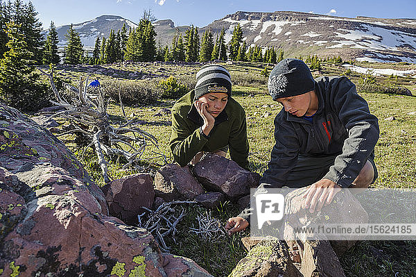 Boys light a fire at their camp near treeline in the upper valley of Yellowstone Creek  below South Kings Peak  during Troop 693's six day backpack trip through the High Uintas Wilderness Area  Uintas Range  Utah