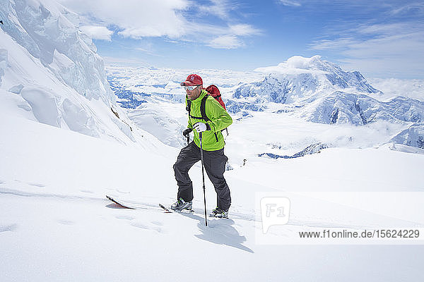 A ski mountaineer on the Kahiltna glacier of Denali National Park in Alaska. Mount Foraker is in the background.