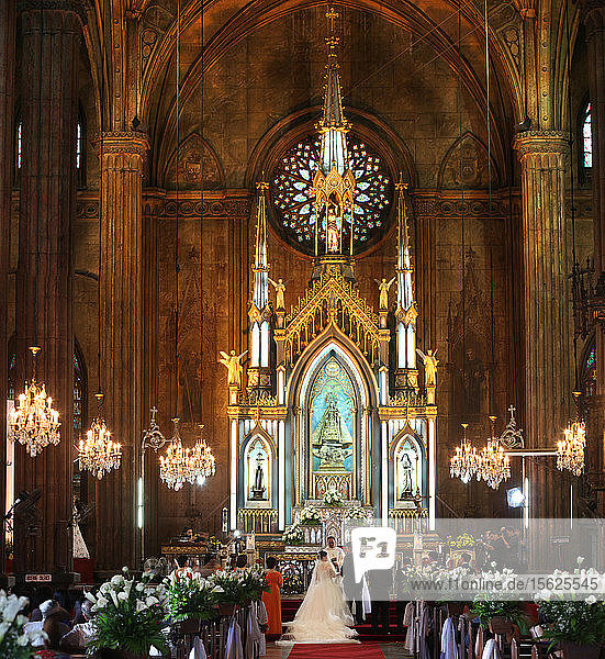 Young couple getting married in San Sebastian Church  Manila  Philippines