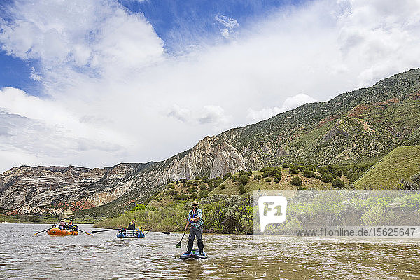 Man Standup Paddleboarding In Green River  Utah  Usa