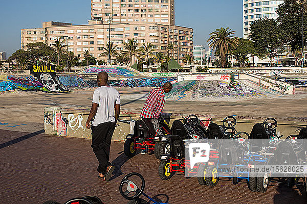 Men preparing go-carts near skate park on promenade of Golden Mile in Durban  South Africa