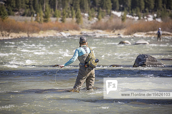 Eine Frau fischt während des Frühjahrsabflusses im Upper Madison River.