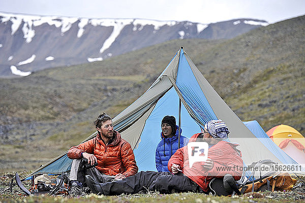 Team enjoys drier climates at base camp while they wait for better wheather conditions during a ski ascent of Mount Sanford Sheep Glacier Route in the Wrangell-St. Elias National Park outside of Glennallen  Alaska June 2011. Mount Sanford at 16 237 feet is the sixth tallest mountain in the United States. (Model Release: Patrick Gilroy  Adam Howard  and Agnes Hage)