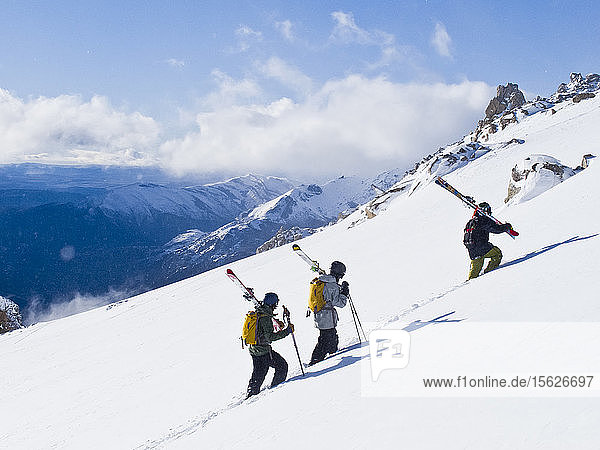 Three Backcountry Skiers Holding Ski Hiking At Cerro Catedral In Argentina