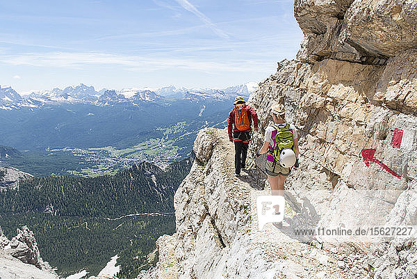 A Couple Climbing At The Via Ferrata Ivano Dibona In Dolomites  Italy