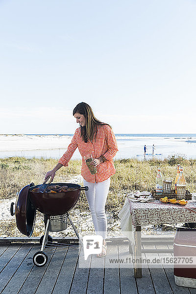 A woman grilling on the beach in Florida