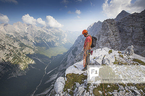 A mountain guide is overlooking the Vrata valley after climbing the famous north face of the Triglav  the highest peak in Slovenia