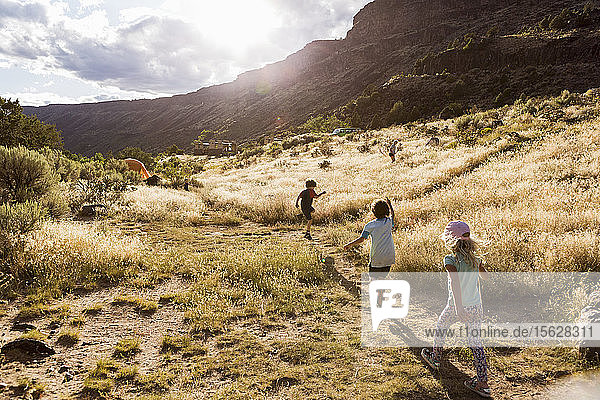 children hiking at sunset Pilar  NM.