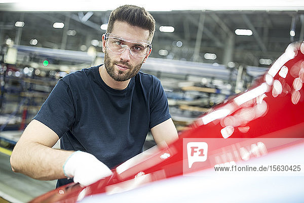 Portrait of confident man working in modern car factory