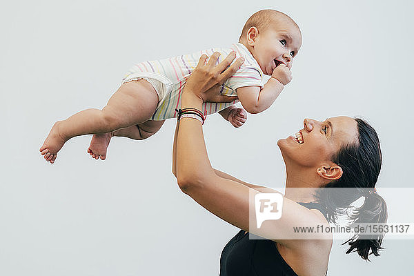 Young mother and baby during mother child gymnastics