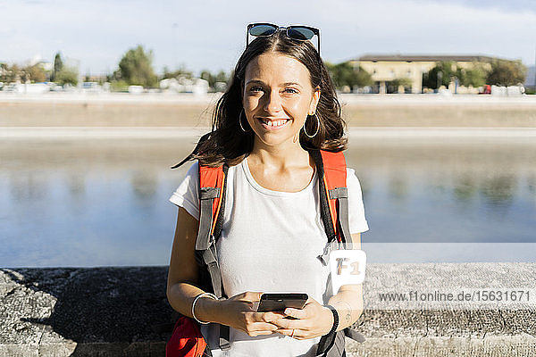 Young female backpacker using smartphone in the city  Verona  Italy