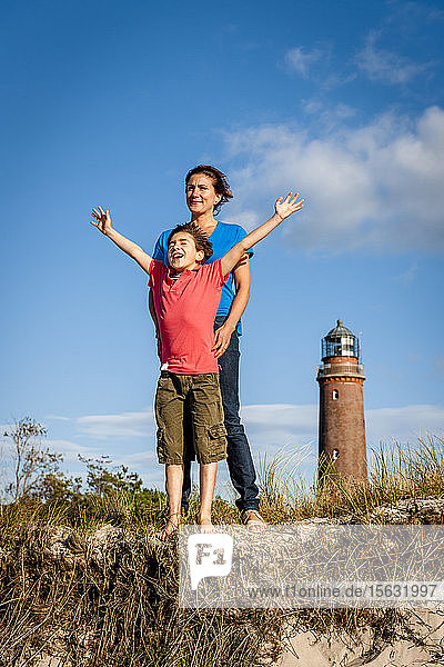 Happy boy with mother standing in a beach dune  Darss  Mecklenburg-Western Pomerania  Germany
