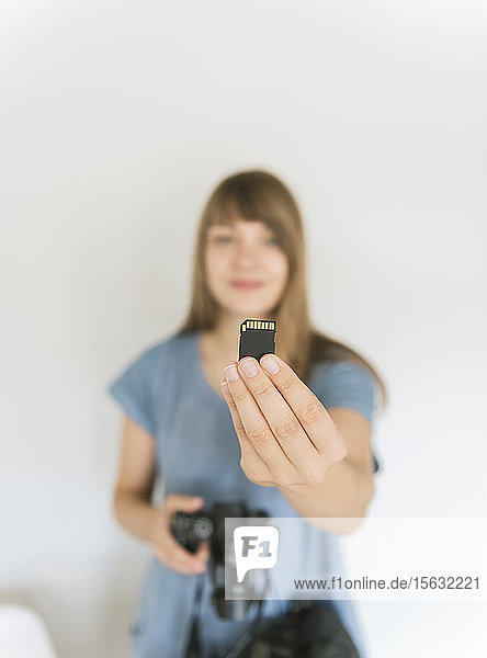 Woman's hand holding memory card  close-up
