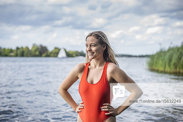 Smiling woman standing at a lake