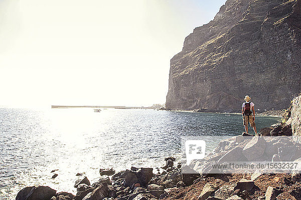 Rear view of hiker at the beach  Valle Gran Grey  La Gomera  Canary Islands  Spain