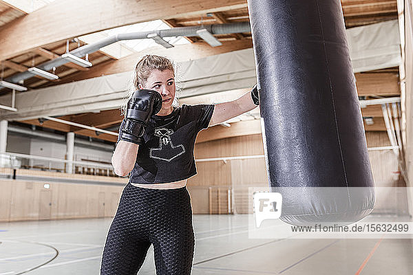 Boxerin übt am Boxsack in der Sporthalle
