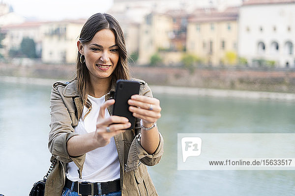 Young brunette woman using smartphone in Verona Italy