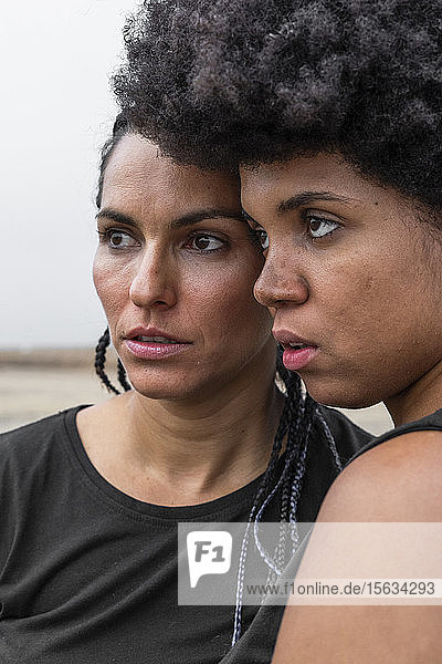 Portrait of two women head to head looking at distance