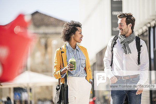 Young man and woman in the city on the go