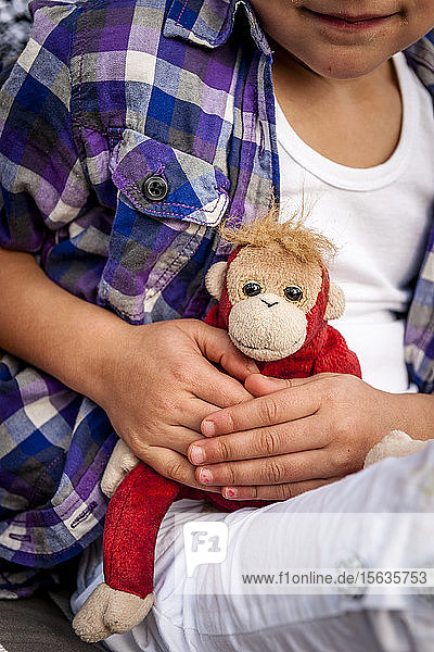 Close-up of little girl holding cuddly toy