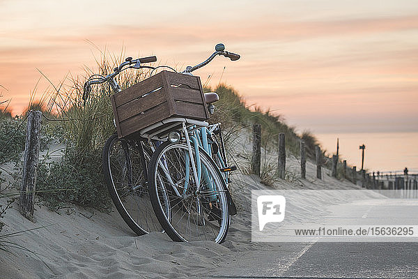 Netherlands  South Holland  Noordwijk  bicycles on sandy beach at sunset