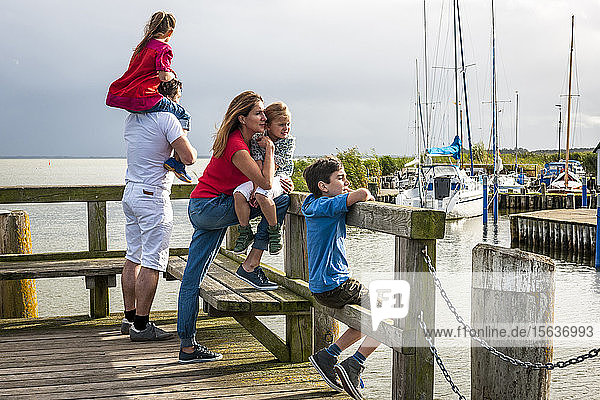 Family standing on a pier looking at view  Ahrenshoop  Mecklenburg-Western Pomerania  Germany