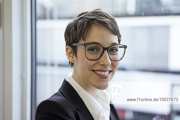 Portait of smiling young businesswoman at the window