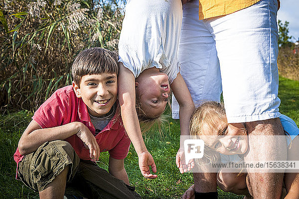 Portrait of happy children with father outdoors
