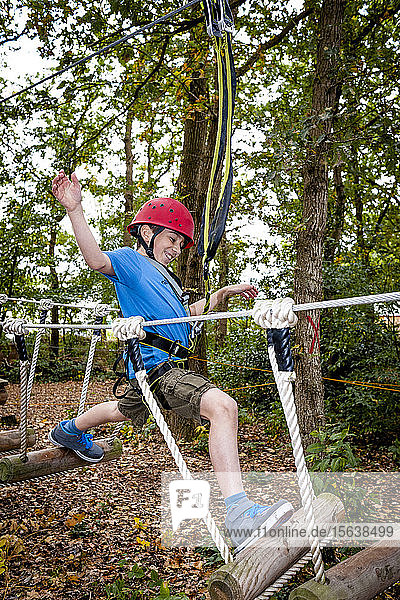 Boy on a rope course in forest