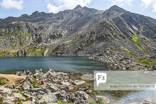 Hikers and swimmers at Gold Cord Lake in summertime in the Independence Mines area of Hatcher Pass near Palmer  South-central Alaska; Alaska  United States of America
