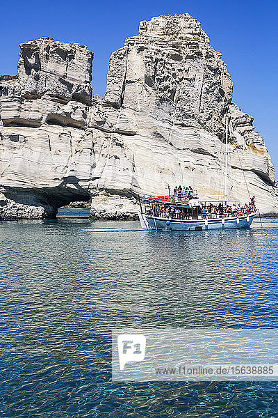 Tourists on tour boat in Kleftiko Bay; Milos Island Cyclades Greece