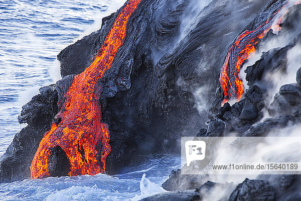 The Pahoehoe lava flowing from Kilauea has reached the Pacific ocean near Kalapana  Big Island; Island of Hawaii  Hawaii  United States of America