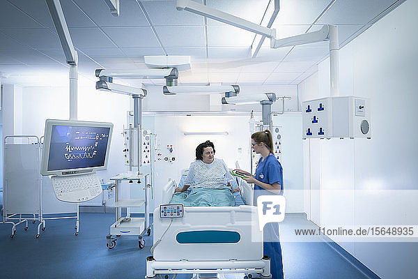 Nurse and patient in intensive care unit in hospital setting