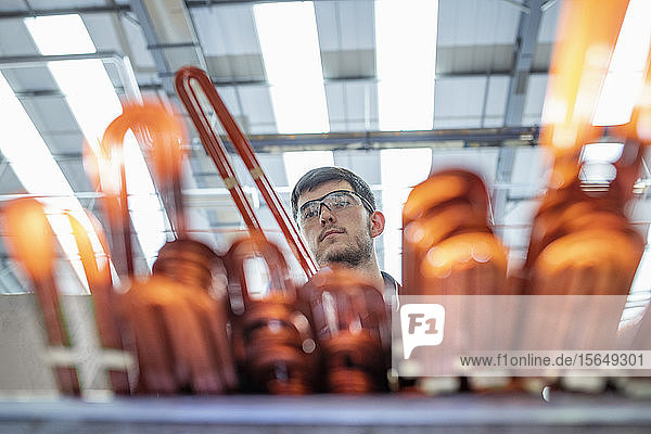 Electrical engineer inspecting copper windings in electrical engineering factory