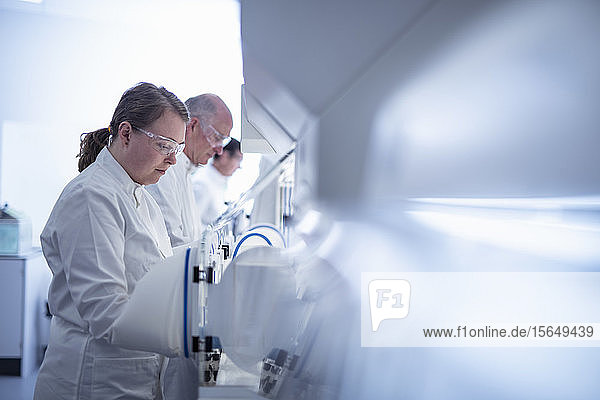 Scientists working with anaerobic cabinets in laboratory