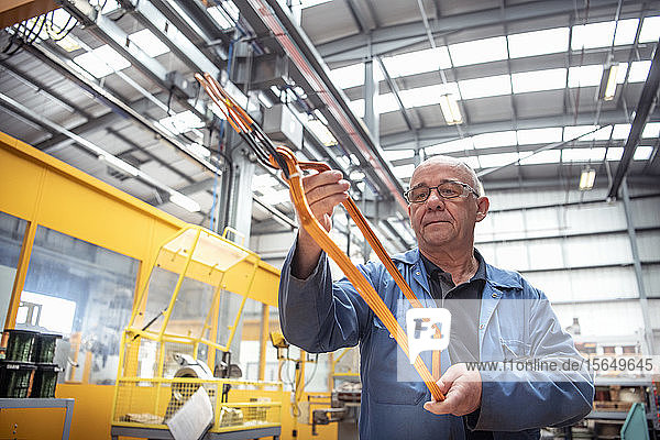 Electrical engineer inspecting copper windings in electrical engineering factory