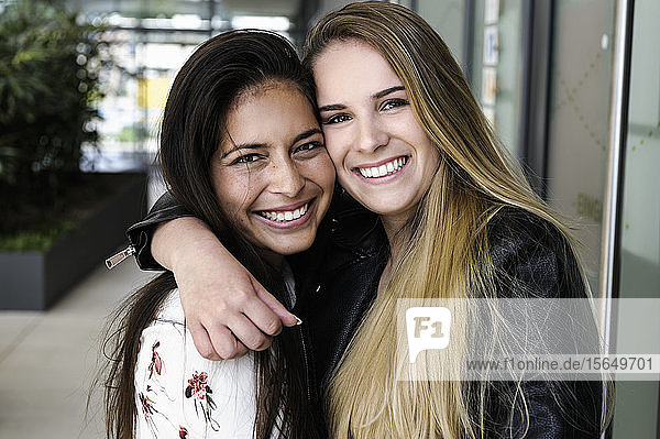 Female students hugging in campus