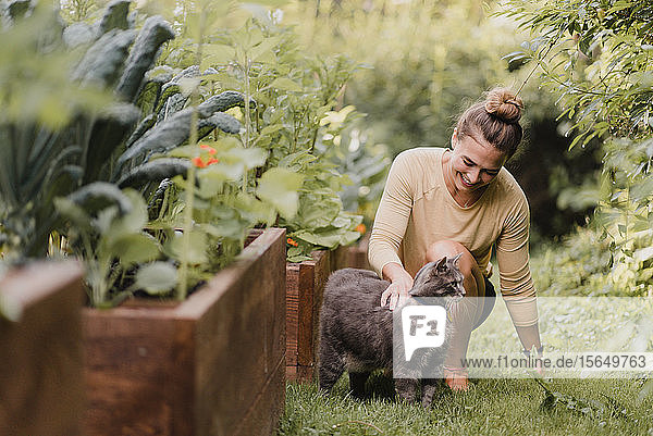 Gärtnerin mit Katze im Garten