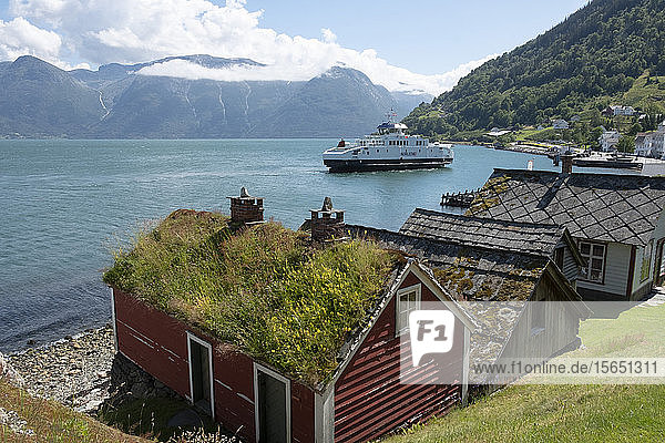 A ferry leaving the village of Utne on Hardanger Fjord Vestlandet Norway Scandinavia