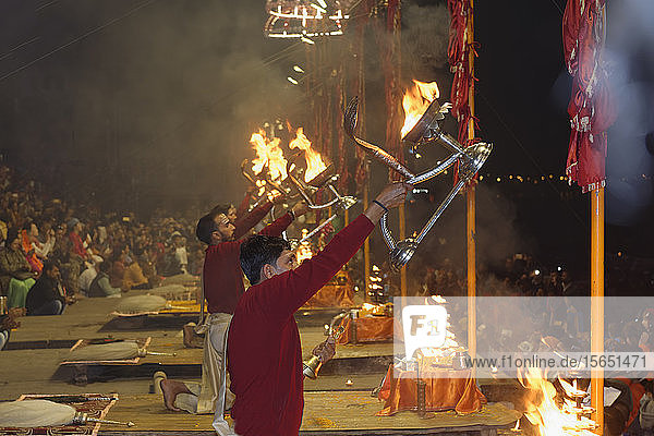 Priests celebrating the River Ganges  Aarti by offering incense  Dashashwamedh Ghat  Varanasi  Uttar Pradesh  India  Asia