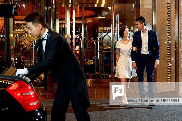 The young couple leave the luxury hotel