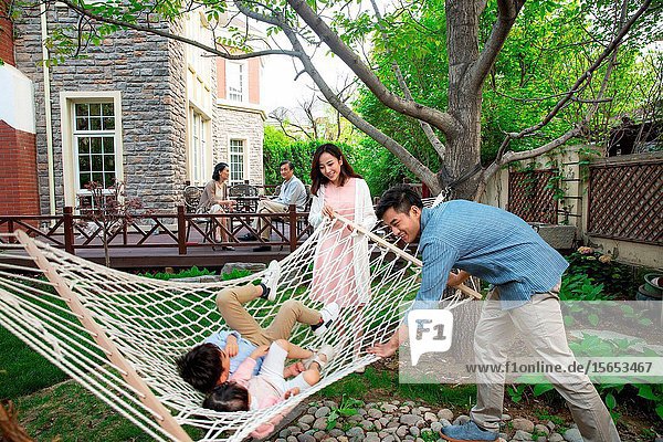 Happy family playing in the courtyard