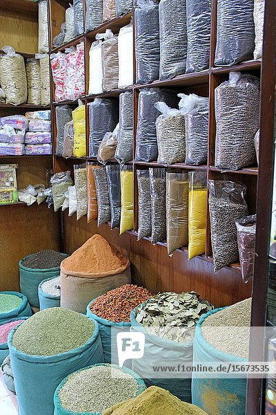 Oriental spices and seasonings in transparent package on shelves of shop. Wealth of eastern market. Ingredients for delicious food on market for sale. Packages with seasonings and oriental spices.