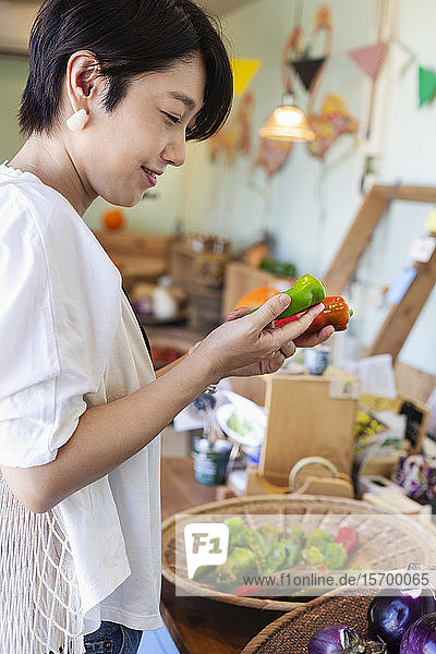 Japanese women shopping fresh vegetables in a farm shop.