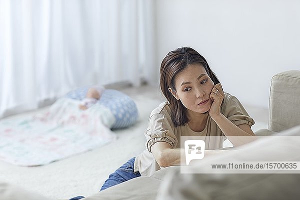 Unhappy Japanese mother with newborn baby