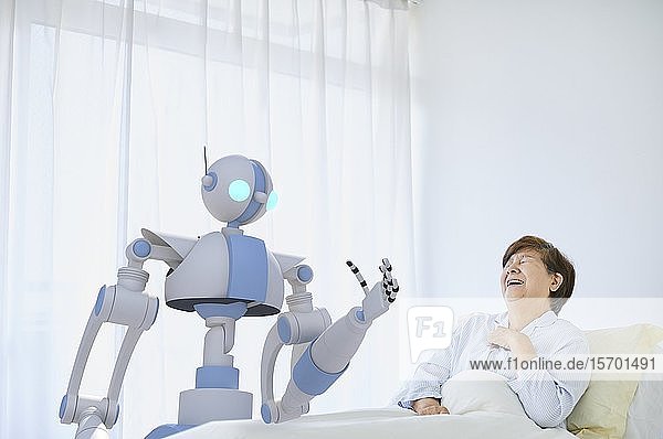Senior Japanese woman with robot