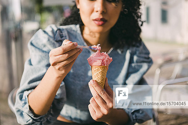 Young woman eating ice cream cone