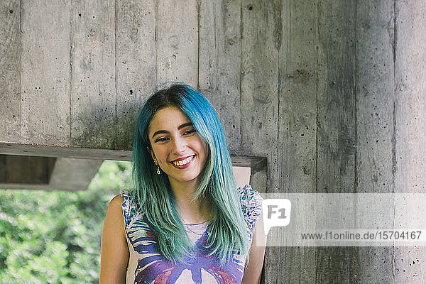 Portrait smiling young woman with blue hair