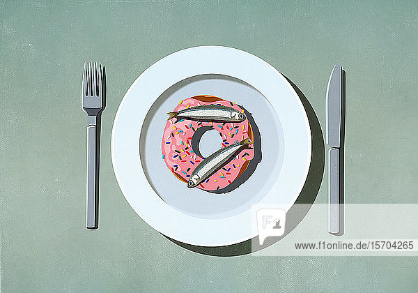 Sardinen oben auf dem Donut auf dem Teller