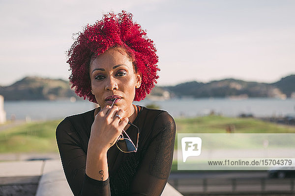 Portrait confident  serious woman with red hair
